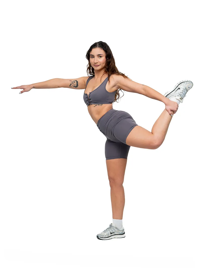 Personal branding lifestyle portrait of a woman in athletic wear stretching