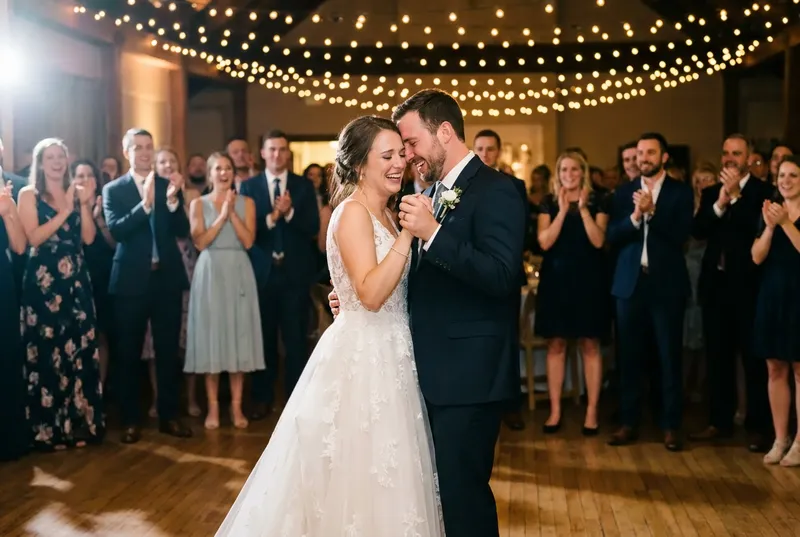 Couple dancing at their wedding reception under string lights